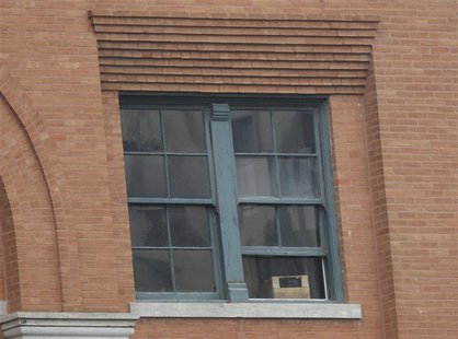 The sixth floor window of the Texas Book Depository, where Lee Harvey Oswald was positioned when he shot President John F. Kennedy, is pictu The sixth floor window of the Texas Book Depository, where Lee Harvey Oswald was positioned when he shot President John F. Kennedy, is pictu