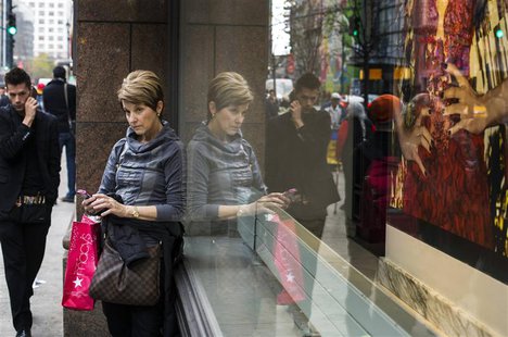 A woman stops to use her phone in front of holiday window displays at Macy's flagship store in New York, November 22, 2013. REUTERS/Lucas Ja A woman stops to use her phone in front of holiday window displays at Macy's flagship store in New York, November 22, 2013. REUTERS/Lucas Ja