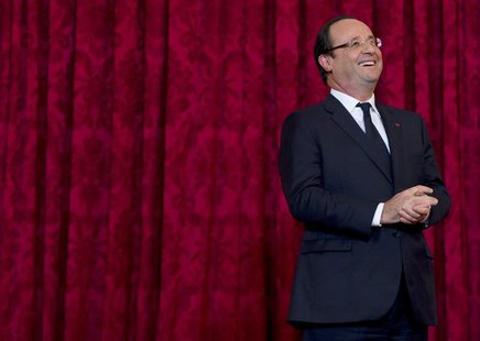 France's President Francois Hollande reacts during a ceremony where he named French singer and actress Line Renaud a "Grand Officier de la L France's President Francois Hollande reacts during a ceremony where he named French singer and actress Line Renaud a "Grand Officier de la L