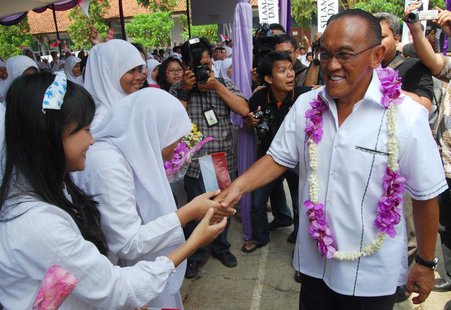 Indonesian billionaire businessman and chairman of Golkar Aburizal Bakrie (R) greets school students during a roadshow in Tangerang outskirt Indonesian billionaire businessman and chairman of Golkar Aburizal Bakrie (R) greets school students during a roadshow in Tangerang outskirt