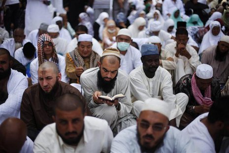 A Muslim pilgrim reads the Koran as he attends Friday prayers at the Grand mosque in the holy city of Mecca ahead of the annual haj pilgrima A Muslim pilgrim reads the Koran as he attends Friday prayers at the Grand mosque in the holy city of Mecca ahead of the annual haj pilgrima