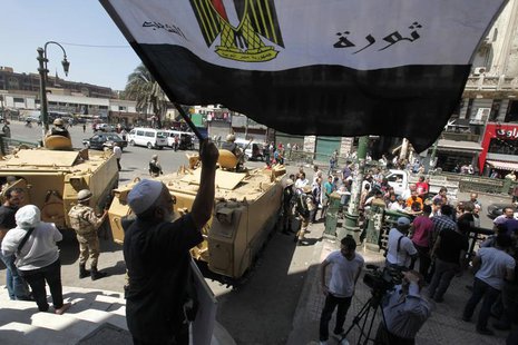 Protesters and activists shout slogans in protest against former president Hosni Mubarak's release from prison, in front of the courthouse a Protesters and activists shout slogans in protest against former president Hosni Mubarak's release from prison, in front of the courthouse a