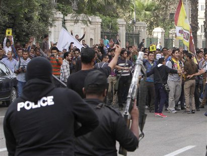 Students of Cairo University, who are supporters of the Muslim Brotherhood and ousted Egyptian President Mohamed Mursi, shout slogans agains Students of Cairo University, who are supporters of the Muslim Brotherhood and ousted Egyptian President Mohamed Mursi, shout slogans agains