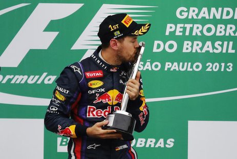 Red Bull Formula One driver Sebastian Vettel of Germany kisses the trophy as he celebrates on the podium after the Brazilian F1 Grand Prix a Red Bull Formula One driver Sebastian Vettel of Germany kisses the trophy as he celebrates on the podium after the Brazilian F1 Grand Prix a