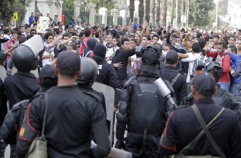 Students of Cairo University, who are supporters of the Muslim Brotherhood and ousted Egyptian President Mohamed Mursi, shout slogans agains Students of Cairo University, who are supporters of the Muslim Brotherhood and ousted Egyptian President Mohamed Mursi, shout slogans agains