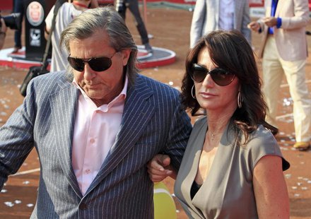 Gymnast Nadia Comaneci (R) and former tennis player Ilie Nastase of Romania leave the court after the awards ceremony at the Bucharest Inter Gymnast Nadia Comaneci (R) and former tennis player Ilie Nastase of Romania leave the court after the awards ceremony at the Bucharest Inter
