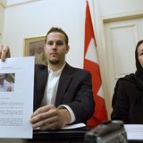 Christine Levinson (R), wife of former FBI agent Robert Levinson, watches as her son Daniel Levinson displays a web print of his father's pi Christine Levinson (R), wife of former FBI agent Robert Levinson, watches as her son Daniel Levinson displays a web print of his father's pi