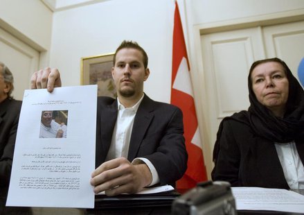 Christine Levinson (R), wife of former FBI agent Robert Levinson, watches as her son Daniel Levinson displays a web print of his father's pi Christine Levinson (R), wife of former FBI agent Robert Levinson, watches as her son Daniel Levinson displays a web print of his father's pi