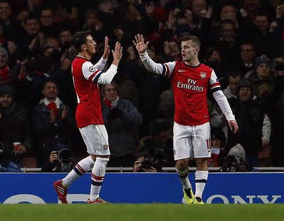 Arsenal's Jack Wilshere (R) celebrates with team mate Mesut Ozil after scoring a goal against Olympique Marseille during their Champions Lea Arsenal's Jack Wilshere (R) celebrates with team mate Mesut Ozil after scoring a goal against Olympique Marseille during their Champions Lea