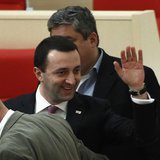 Georgia's Prime Minister Irakly Garibashvili (C) waves as he is congratulated by members of parliament during a session in parliament in Kut Georgia's Prime Minister Irakly Garibashvili (C) waves as he is congratulated by members of parliament during a session in parliament in Kut