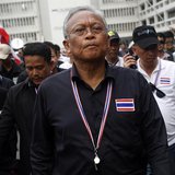 Protest leader and former deputy prime minister Suthep Thaugsuban (C) walks in the Finance Ministry compound after anti-government protester Protest leader and former deputy prime minister Suthep Thaugsuban (C) walks in the Finance Ministry compound after anti-government protester
