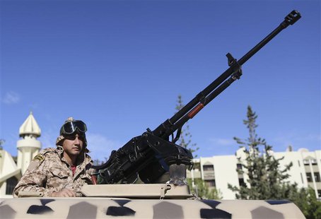 A member of the Libyan army guards the streets following yesterday's clashes in Benghazi November 26, 2013. REUTERS/Esam Omran Al-Fetori A member of the Libyan army guards the streets following yesterday's clashes in Benghazi November 26, 2013. REUTERS/Esam Omran Al-Fetori