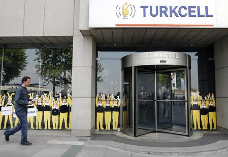 A man walks past the Turkcell head office in Istanbul May 14, 2009. REUTERS/Osman Orsal A man walks past the Turkcell head office in Istanbul May 14, 2009. REUTERS/Osman Orsal