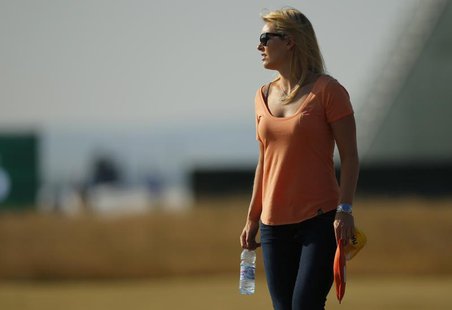 Skier Lindsey Vonn watches her boyfriend, Tiger Woods of the U.S., during a practice round ahead of the British Open golf championship at Mu Skier Lindsey Vonn watches her boyfriend, Tiger Woods of the U.S., during a practice round ahead of the British Open golf championship at Mu
