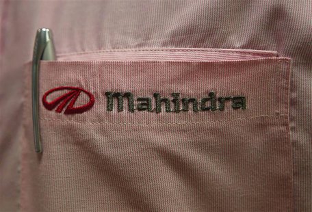 The logo of Mahindra & Mahindra Ltd is pictured on the pocket of a salesman's shirt as he poses inside the company's showroom in Mumbai, in The logo of Mahindra & Mahindra Ltd is pictured on the pocket of a salesman's shirt as he poses inside the company's showroom in Mumbai, in