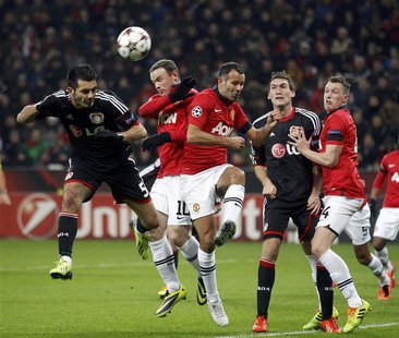 Bayer Leverkusen's Emir Spahic (L) is challenged by Manchester United's Wayne Rooney (2nd L) and Ryan Giggs (3rd L) during their Champions L Bayer Leverkusen's Emir Spahic (L) is challenged by Manchester United's Wayne Rooney (2nd L) and Ryan Giggs (3rd L) during their Champions L