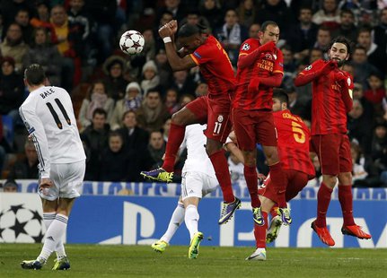 Real Madrid's Gareth Bale (L) kicks the ball to score a goal against Galatasaray during their Champions League soccer match at Santiago Bern Real Madrid's Gareth Bale (L) kicks the ball to score a goal against Galatasaray during their Champions League soccer match at Santiago Bern
