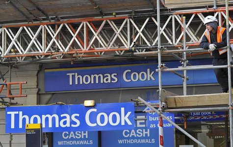 A construction worker stands on scaffolding in front of a branch of Thomas Cook in London December 14, 2011. REUTERS/Toby Melville A construction worker stands on scaffolding in front of a branch of Thomas Cook in London December 14, 2011. REUTERS/Toby Melville