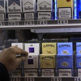A shopkeeper reaches for a packet of cigarettes in a newsagent in London March 9, 2011. REUTERS/Stefan Wermuth A shopkeeper reaches for a packet of cigarettes in a newsagent in London March 9, 2011. REUTERS/Stefan Wermuth
