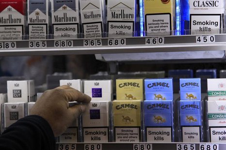 A shopkeeper reaches for a packet of cigarettes in a newsagent in London March 9, 2011. REUTERS/Stefan Wermuth A shopkeeper reaches for a packet of cigarettes in a newsagent in London March 9, 2011. REUTERS/Stefan Wermuth