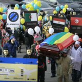 People dressed in outfits of various popular professions in Ukraine carry a coffin symbolising Ukraine's Euro-association and an airplane ti People dressed in outfits of various popular professions in Ukraine carry a coffin symbolising Ukraine's Euro-association and an airplane ti