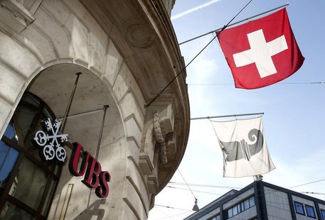 A Swiss national flag (top) and a flag of the city of Basel fly over the entrance of a branch office of Swiss bank UBS in Basel October 22, A Swiss national flag (top) and a flag of the city of Basel fly over the entrance of a branch office of Swiss bank UBS in Basel October 22,