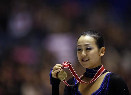 Mao Asada of Japan poses with her gold medal during the award ceremony for the women's free skating programme at the ISU Grand Prix of Figur Mao Asada of Japan poses with her gold medal during the award ceremony for the women's free skating programme at the ISU Grand Prix of Figur
