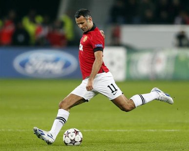 Manchester United's Ryan Giggs kicks the ball during the Champions League Group A soccer match against Bayer Leverkusen at the BayArena in L Manchester United's Ryan Giggs kicks the ball during the Champions League Group A soccer match against Bayer Leverkusen at the BayArena in L