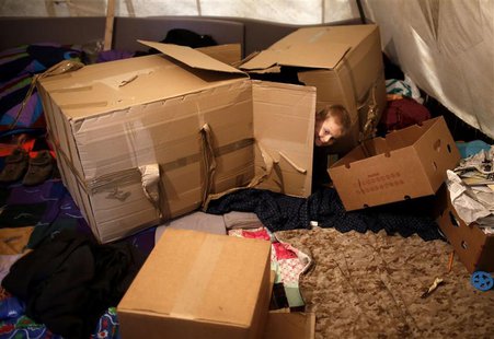 A Muslim Bosniak child plays amongst boxes in a camp in Sarajevo, November 19, 2013. REUTERS/Dado Ruvic A Muslim Bosniak child plays amongst boxes in a camp in Sarajevo, November 19, 2013. REUTERS/Dado Ruvic