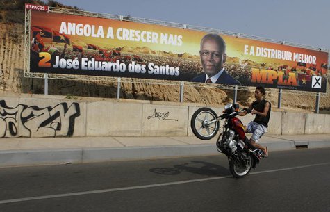 A motorcyclist rides past an election poster of the ruling MPLA party with the picture of President Jose Eduardo dos Santos in the capital L A motorcyclist rides past an election poster of the ruling MPLA party with the picture of President Jose Eduardo dos Santos in the capital L