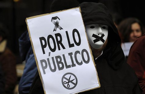 A protestor wears a mask with black tape over the mouth during a demonstration against government austerity measures and the passing of a ne A protestor wears a mask with black tape over the mouth during a demonstration against government austerity measures and the passing of a ne