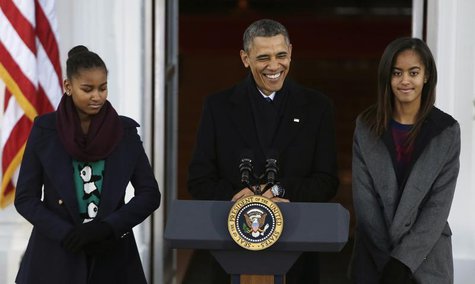U.S. President Barack Obama and his daughters Malia (R) and Sasha (L) appear at the North Portico of the White House to pardon the annual Pr U.S. President Barack Obama and his daughters Malia (R) and Sasha (L) appear at the North Portico of the White House to pardon the annual Pr