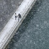 Two joggers run along the embankment of Aare river during the first snowfall in Bern November 21, 2013. REUTERS/Ruben Sprich Two joggers run along the embankment of Aare river during the first snowfall in Bern November 21, 2013. REUTERS/Ruben Sprich
