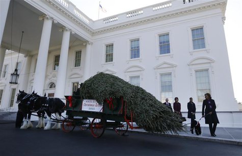 U.S. first lady Michelle Obama (R) and her daughters Sasha and Malia welcome the official White House Christmas tree at the North Portico of U.S. first lady Michelle Obama (R) and her daughters Sasha and Malia welcome the official White House Christmas tree at the North Portico of