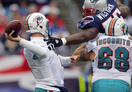 Miami Dolphins guard Richie Incognito (68) tries to stop New England Patriots defensive tackle Vince Wilfork (top R) from sacking Dolphins q Miami Dolphins guard Richie Incognito (68) tries to stop New England Patriots defensive tackle Vince Wilfork (top R) from sacking Dolphins q