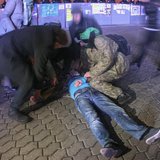 People help a protester after a scuffle with the police during a demonstration in support of EU integration at Independence Square in Kiev N People help a protester after a scuffle with the police during a demonstration in support of EU integration at Independence Square in Kiev N