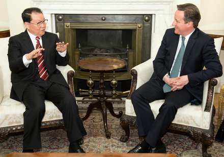 Li Changchun, a member of China's Standing Committee of the Political Bureau (L) speaks to Britain's Prime Minister David Cameron during the Li Changchun, a member of China's Standing Committee of the Political Bureau (L) speaks to Britain's Prime Minister David Cameron during the