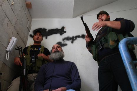 Sunni Muslim fighters stand with their weapons inside a building in Tripoli, northern Lebanon, November 30, 2013. REUTERS/Omar Ibrahim Sunni Muslim fighters stand with their weapons inside a building in Tripoli, northern Lebanon, November 30, 2013. REUTERS/Omar Ibrahim
