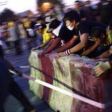 Anti-government protesters tear down barricades during a demonstration outside Government House in Bangkok November 30, 2013. REUTERS/Dylan Anti-government protesters tear down barricades during a demonstration outside Government House in Bangkok November 30, 2013. REUTERS/Dylan