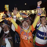 Anti-government protesters cheer after they tear down barricades during a demonstration outside Government House in Bangkok November 30, 201 Anti-government protesters cheer after they tear down barricades during a demonstration outside Government House in Bangkok November 30, 201