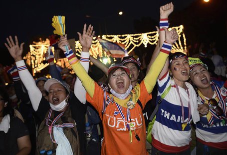 Anti-government protesters cheer after they tear down barricades during a demonstration outside Government House in Bangkok November 30, 201 Anti-government protesters cheer after they tear down barricades during a demonstration outside Government House in Bangkok November 30, 201