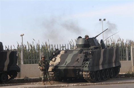 Lebanese army soldiers stand by a tank while monitoring a street in Tripoli, northern Lebanon, November 30, 2013. REUTERS/Stringer Lebanese army soldiers stand by a tank while monitoring a street in Tripoli, northern Lebanon, November 30, 2013. REUTERS/Stringer