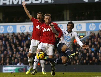 Tottenham Hotspur's Paulinho (R) challenges Manchester United's Wayne Rooney during their English Premier League soccer match at White Hart Tottenham Hotspur's Paulinho (R) challenges Manchester United's Wayne Rooney during their English Premier League soccer match at White Hart