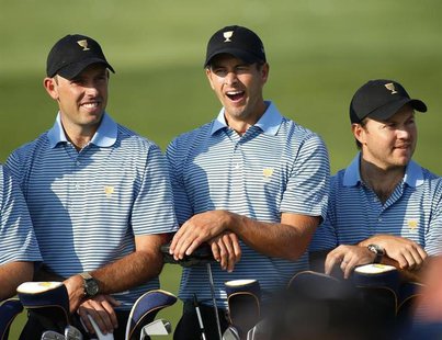 International Team player Adam Scott, of Australia, yawns as he poses for a team picture between Charl Schwartzel (L) and Richard Sterne (R) International Team player Adam Scott, of Australia, yawns as he poses for a team picture between Charl Schwartzel (L) and Richard Sterne (R)