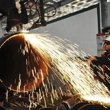 A worker operates a machine to cut a pipeline at a factory in Qingdao, Shandong province November 29, 2013. REUTERS/China Daily A worker operates a machine to cut a pipeline at a factory in Qingdao, Shandong province November 29, 2013. REUTERS/China Daily