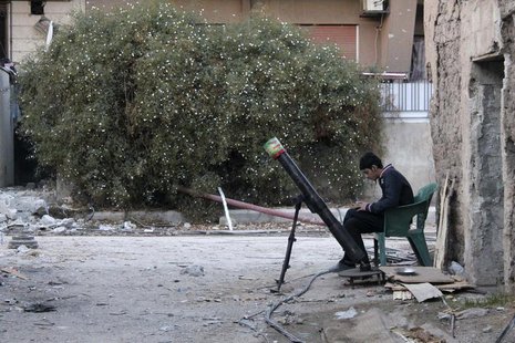 A Free Syrian Army fighter listens to music as he sits beside a rocket launcher, on a damaged street in the Jobar neighbourhood of Damascus A Free Syrian Army fighter listens to music as he sits beside a rocket launcher, on a damaged street in the Jobar neighbourhood of Damascus