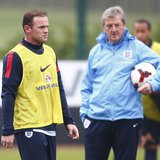England national team soccer player Wayne Rooney (L) walks past manager Roy Hodgson during a team training session at Arsenal's training fac England national team soccer player Wayne Rooney (L) walks past manager Roy Hodgson during a team training session at Arsenal's training fac