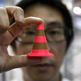 A staff of Nihonbinary shows an Acrylonitrile butadiene styrene pylon which is printed by the 3D printer MakerBot Replicator 2X during the I A staff of Nihonbinary shows an Acrylonitrile butadiene styrene pylon which is printed by the 3D printer MakerBot Replicator 2X during the I