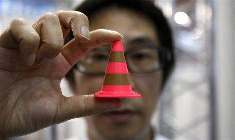 A staff of Nihonbinary shows an Acrylonitrile butadiene styrene pylon which is printed by the 3D printer MakerBot Replicator 2X during the I A staff of Nihonbinary shows an Acrylonitrile butadiene styrene pylon which is printed by the 3D printer MakerBot Replicator 2X during the I
