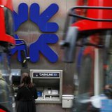 People stand near a branch of Royal Bank of Scotland (RBS) in London November 1, 2013. REUTERS/Luke MacGregor People stand near a branch of Royal Bank of Scotland (RBS) in London November 1, 2013. REUTERS/Luke MacGregor